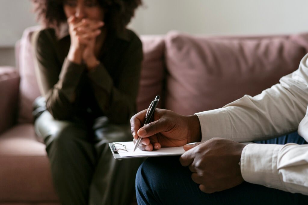 Close-up of a person handing a pen and document to another individual for signing, depicting agreement or consent.